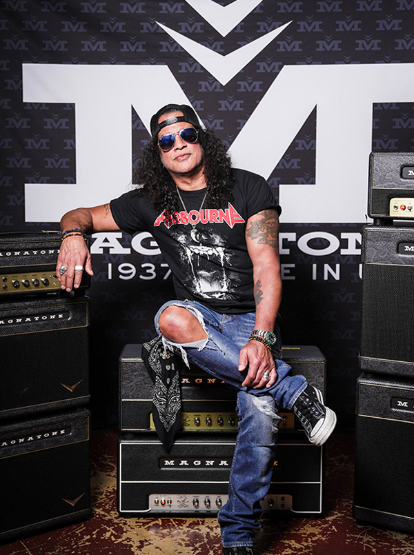 Slash sitting on amps.
